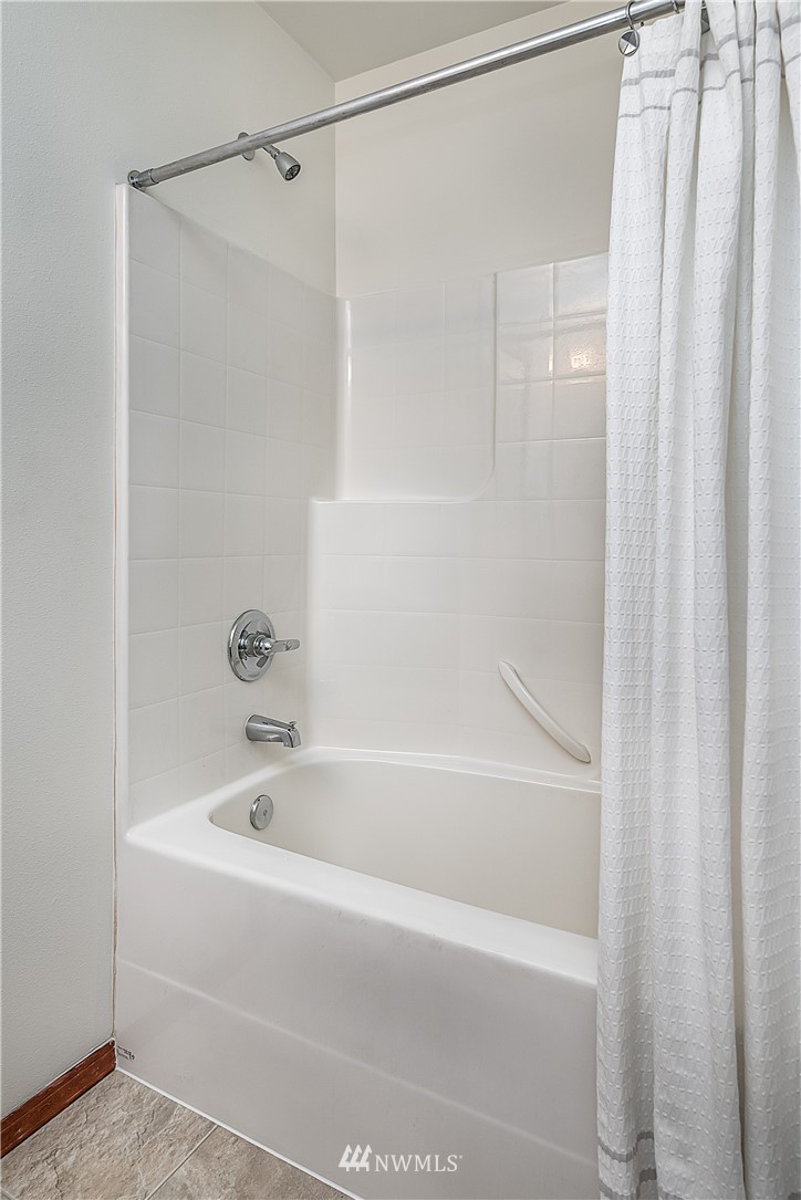 1043 215th Place Southeast Bothell, WA 98021 - Photo 22 of 29 a white bath tub and shower