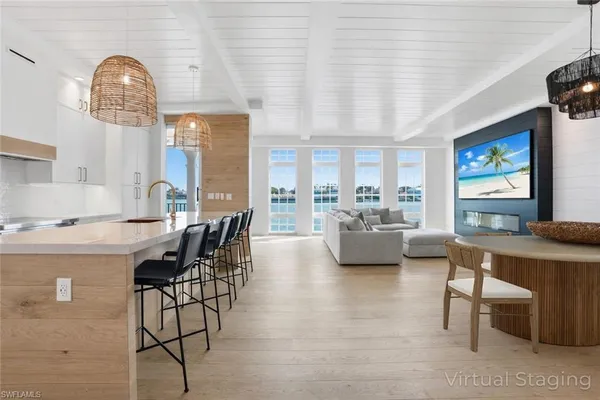 a dining room with furniture and a flat screen tv