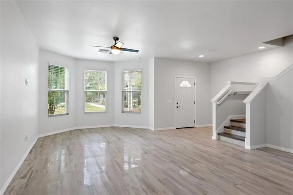 wooden floor in an empty room with a window