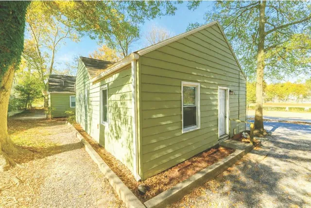 a view of a house with a backyard