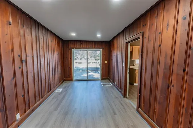 a view of hallway with wooden floor