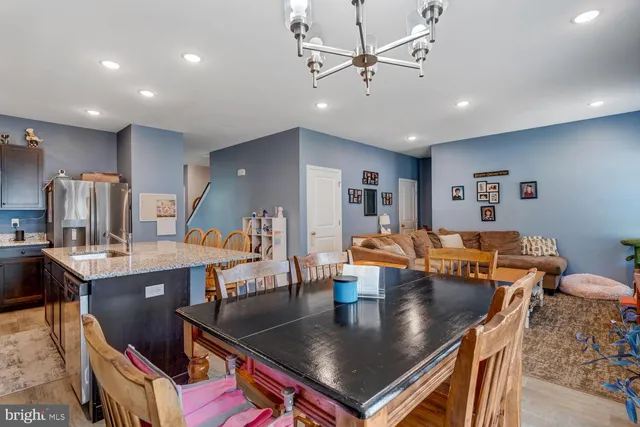 a large kitchen with a table and chairs