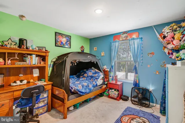 a bedroom with furniture and a flat screen tv