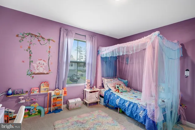 a bedroom with furniture and a window