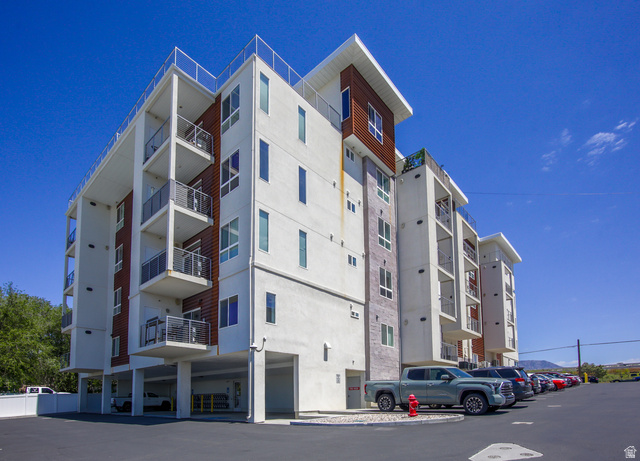 2101 North Main Street, Unit 306 Sunset, UT 84015 - Photo 19 of 22 Contemporary multifamily building featuring a white stucco exterior with wood-finish and stone accents