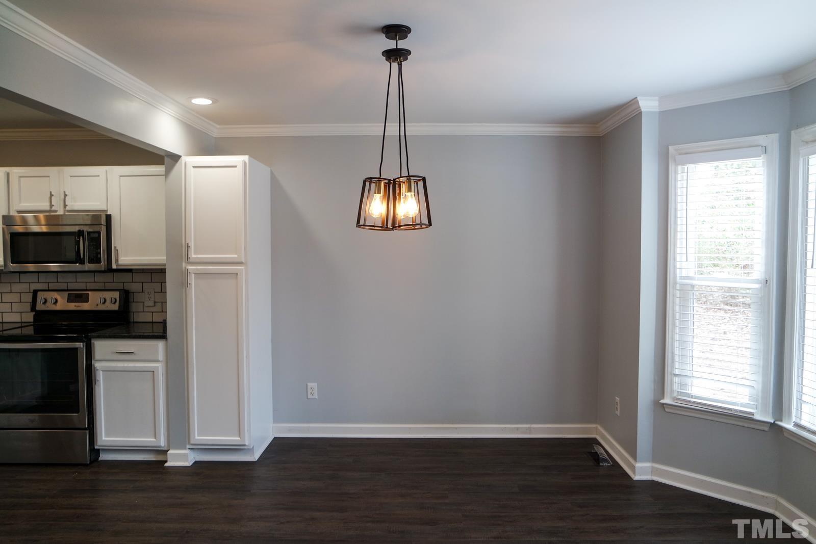 3800 Axle Lane Raleigh, NC 27616 - Photo 2 of 11 a view of a kitchen with wooden floor electronic appliances and a window