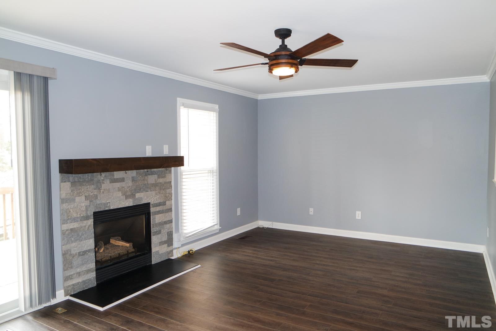 3800 Axle Lane Raleigh, NC 27616 - Photo 5 of 11 a view of a livingroom with a fireplace and wooden floor
