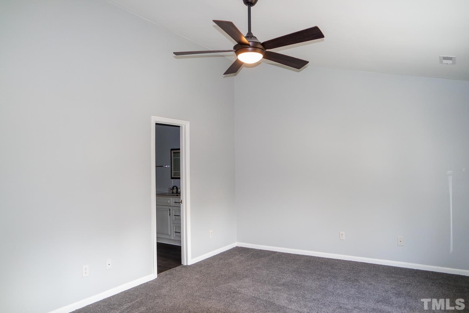 3800 Axle Lane Raleigh, NC 27616 - Photo 6 of 11 an empty room with a ceiling fan and window