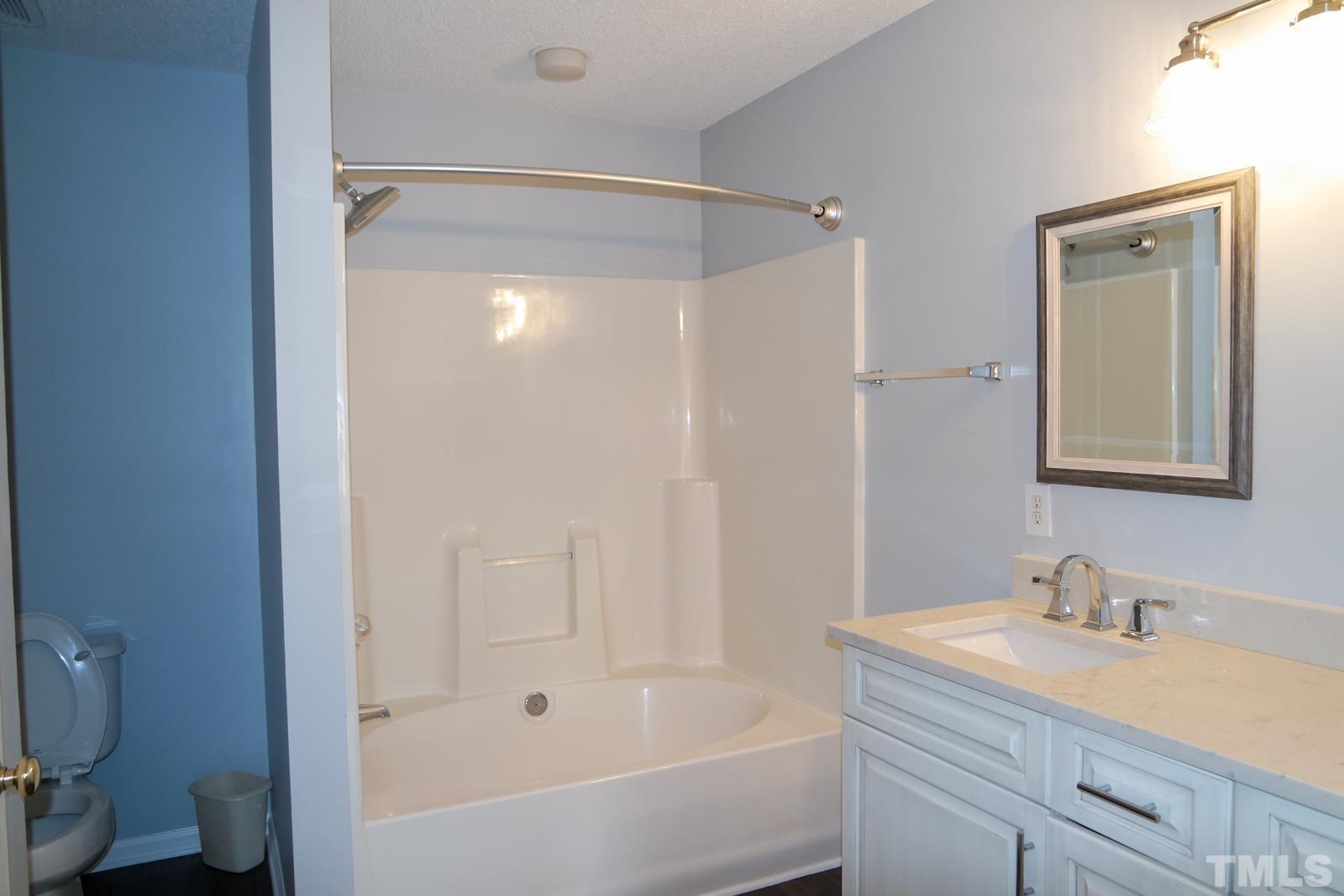 3800 Axle Lane Raleigh, NC 27616 - Photo 8 of 11 a bathroom with a granite countertop sink toilet and shower