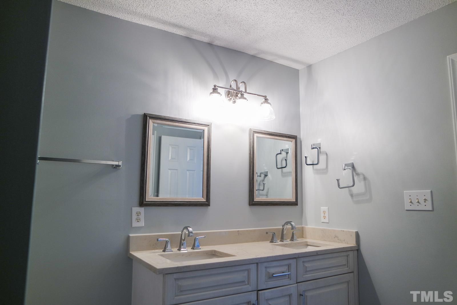 3800 Axle Lane Raleigh, NC 27616 - Photo 9 of 11 a bathroom with double vanity sinks and a mirror