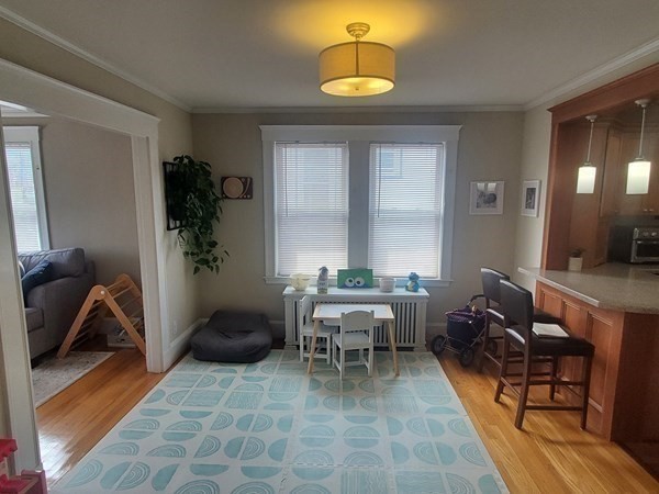 1 Grayson Street, Unit 2 Boston, MA 02124 - Photo 23 of 23 a living room with furniture and a chandelier