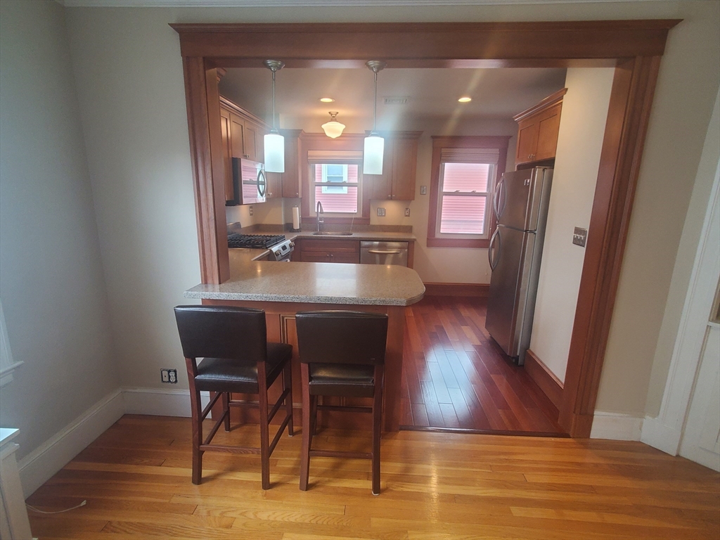 1 Grayson Street, Unit 2 Boston, MA 02124 - Photo 3 of 23 a view of a dining room with furniture and wooden floor