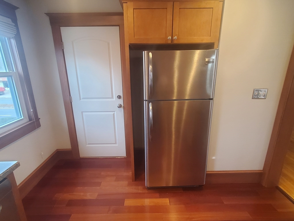 1 Grayson Street, Unit 2 Boston, MA 02124 - Photo 5 of 23 a view of a refrigerator in kitchen and wooden floor