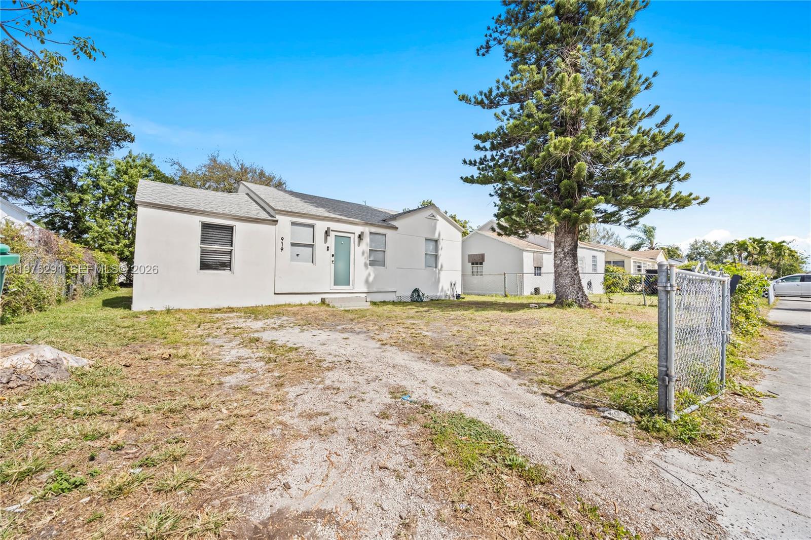 919 Northwest 66th Street Miami, FL 33150 - Photo 1 of 21 a house with trees in front of it