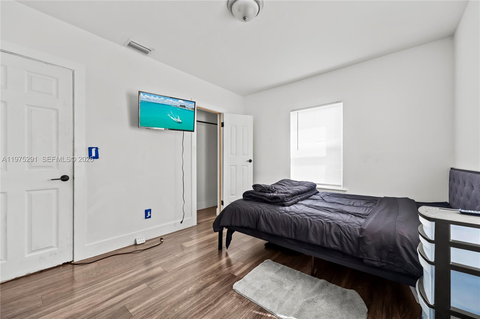 919 Northwest 66th Street Miami, FL 33150 - Photo 11 of 21 a bedroom with a bed and a table