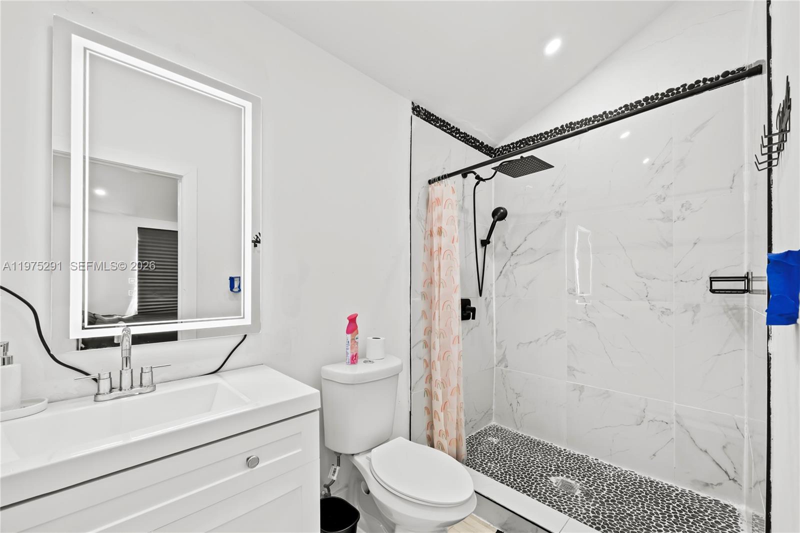 919 Northwest 66th Street Miami, FL 33150 - Photo 14 of 21 a bathroom with a sink toilet and shower