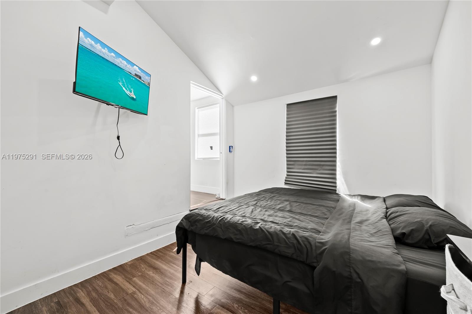 919 Northwest 66th Street Miami, FL 33150 - Photo 15 of 21 a bedroom with a bed and a window