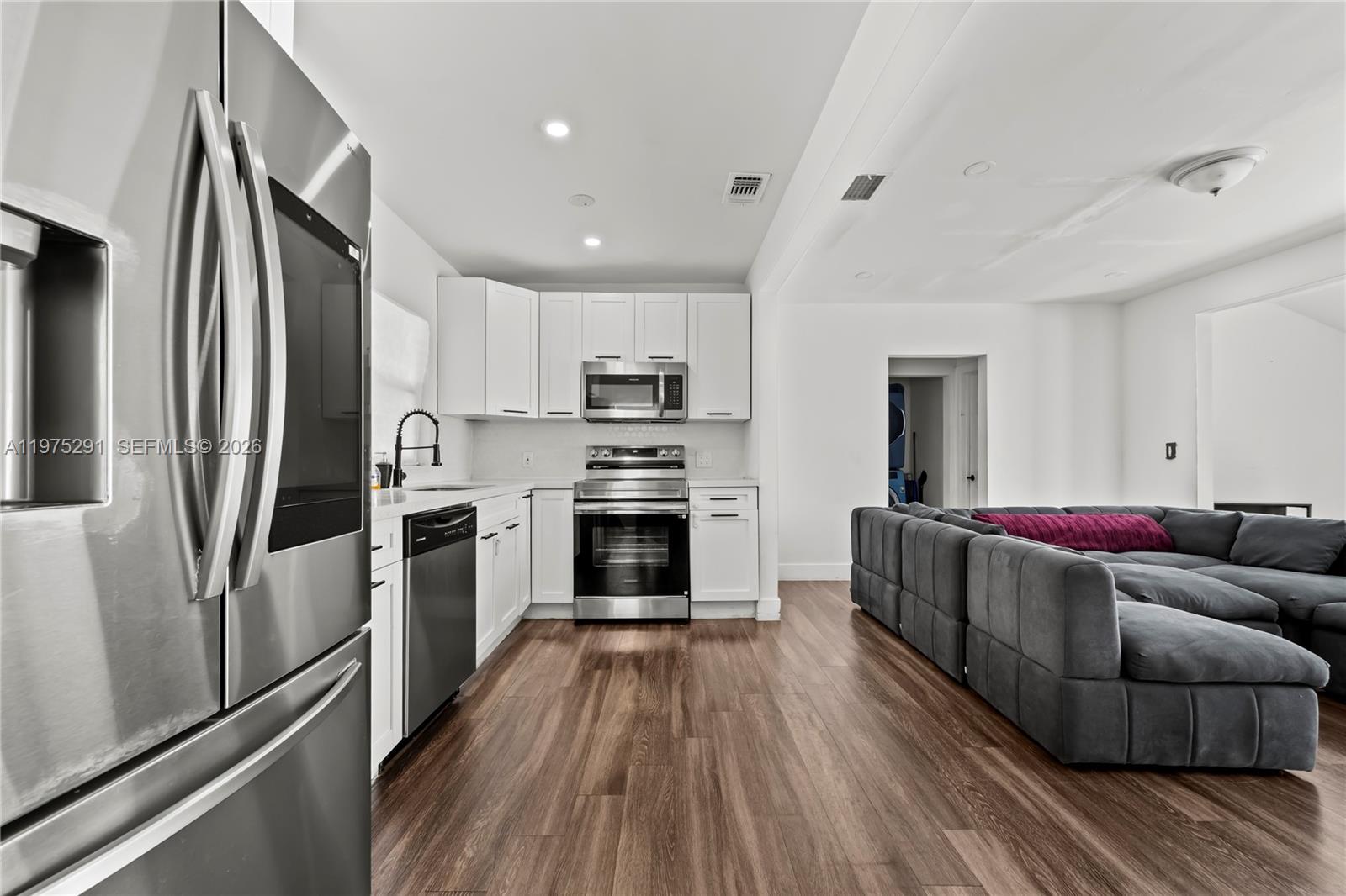 919 Northwest 66th Street Miami, FL 33150 - Photo 5 of 21 a living room with stainless steel appliances furniture a refrigerator and a kitchen view