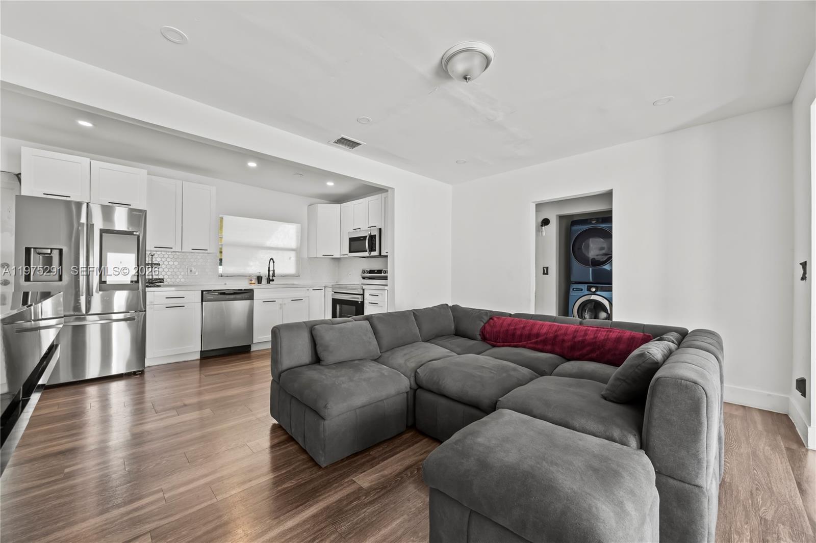 919 Northwest 66th Street Miami, FL 33150 - Photo 7 of 21 a living room with furniture and kitchen view
