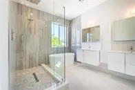 a bathroom with a tub shower and sink