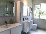 a bathroom with a toilet sink and mirror
