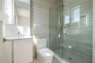 a bathroom with a toilet and a shower
