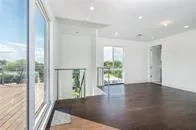 a view of an empty room and wooden floor