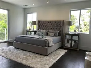 a bedroom with a bed lamp and window