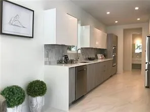 a kitchen with stainless steel appliances granite countertop a refrigerator sink and cabinets
