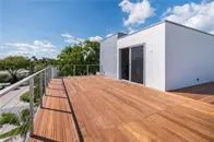 a view of balcony with wooden floor and fence