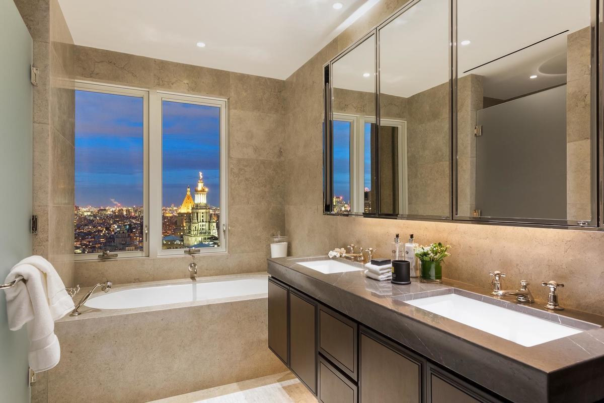 a bathroom with a granite countertop sink and a bathtub