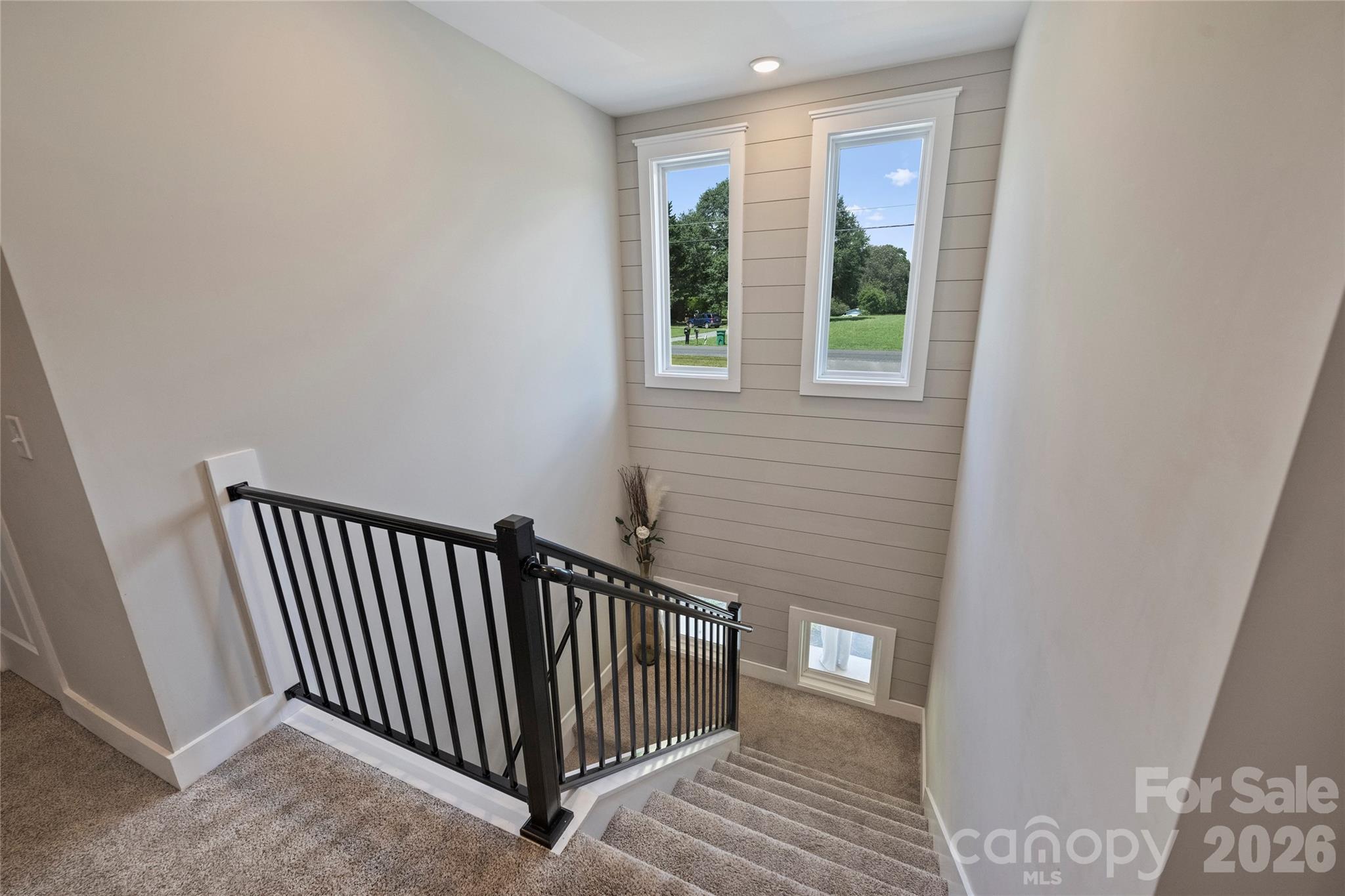 606 Elm Street Locust, NC 28097 - Photo 12 of 23 a view of a hallway with wooden floor and stairs