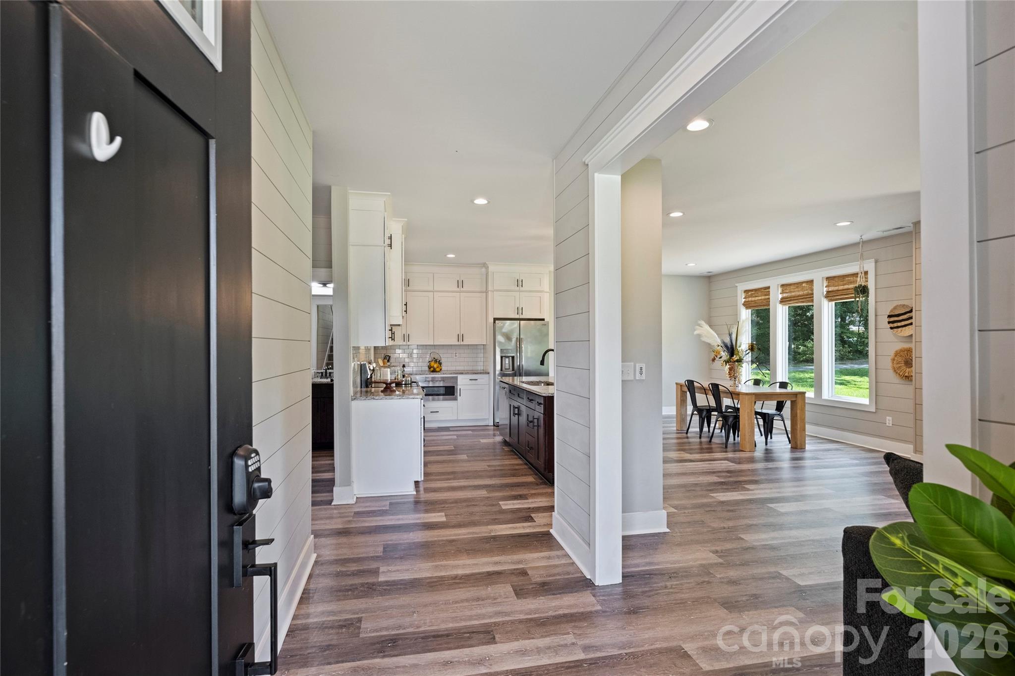 606 Elm Street Locust, NC 28097 - Photo 2 of 23 a view of a kitchen with dining table and chairs