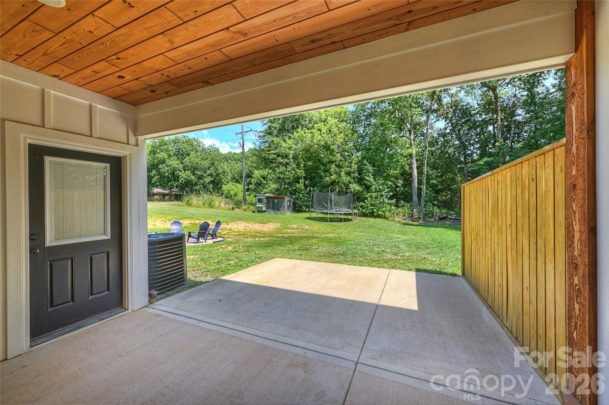 606 Elm Street Locust, NC 28097 - Photo 22 of 23 a view of backyard with large trees and a yard