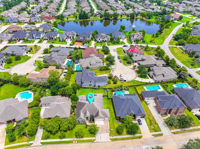 a view of a house with a yard and sitting area