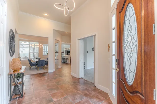 a view of a dining room with furniture and a chandelier