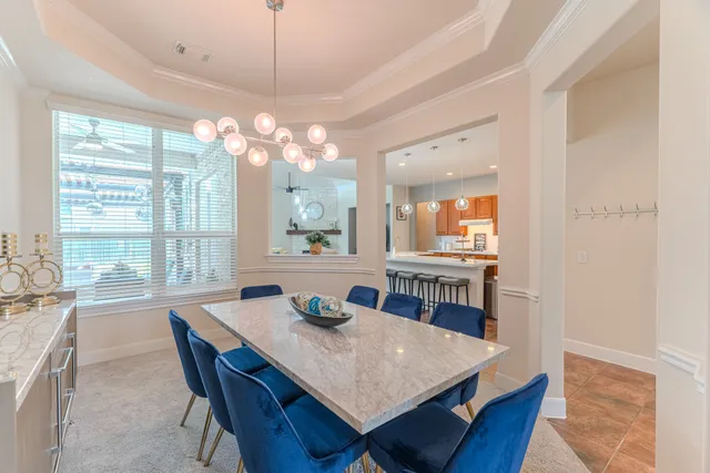 a large white kitchen with a table and chairs