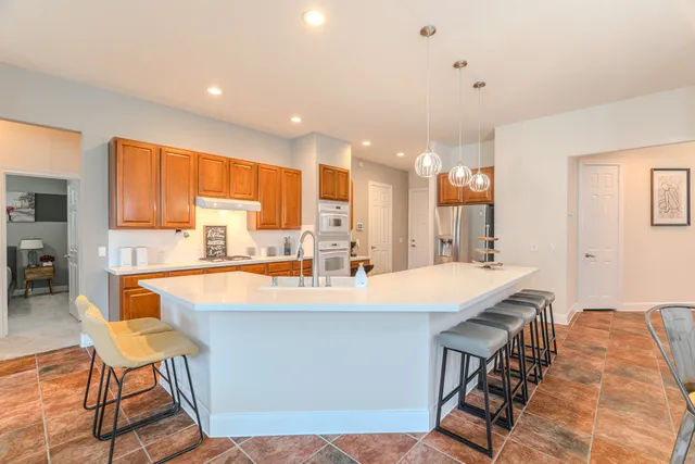 a living room with furniture kitchen view and a flat screen tv