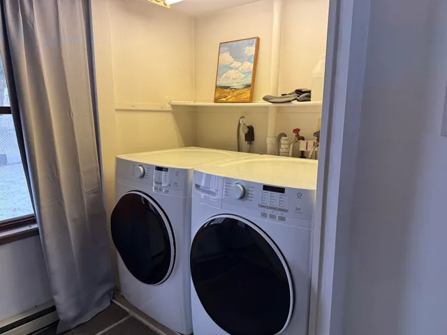 a view of a hallway with washer and dryer