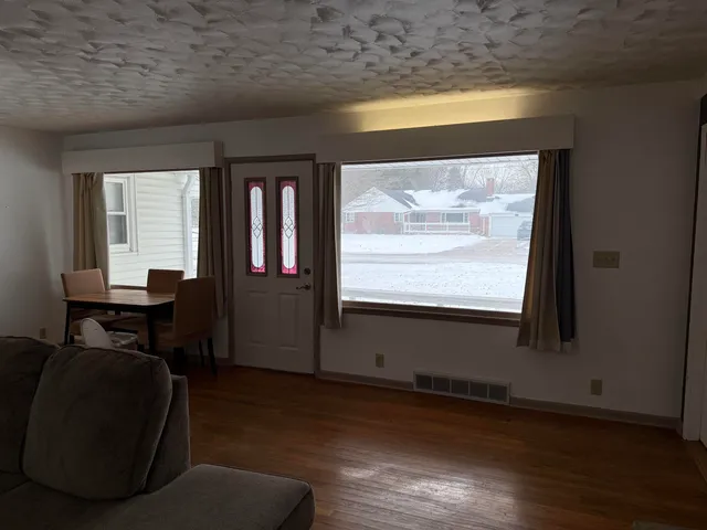 a room with wooden floor and a window