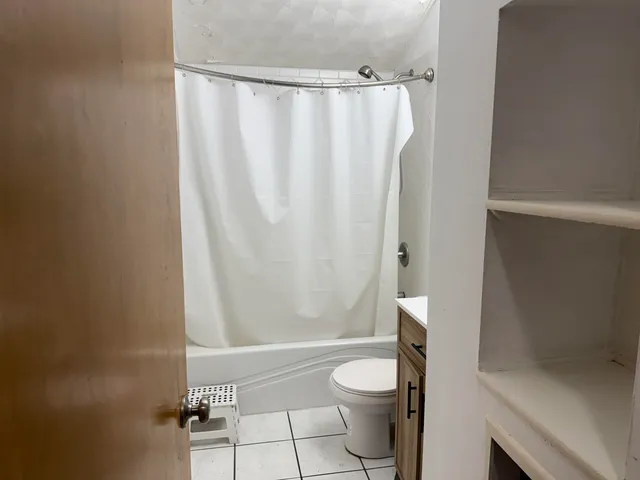 a bathroom with a toilet and a shower