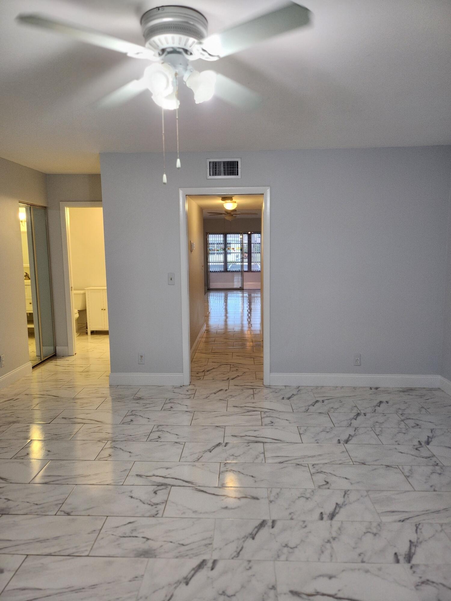 5433 Lakefront Boulevard, Unit B Delray Beach, FL 33484 - Photo 7 of 13 a view of an empty room and window