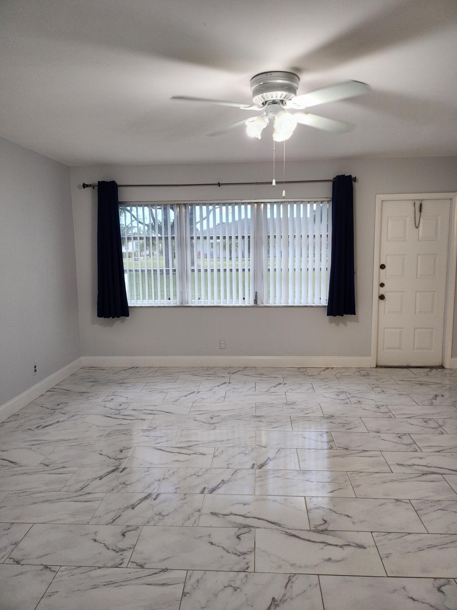 5433 Lakefront Boulevard, Unit B Delray Beach, FL 33484 - Photo 8 of 13 a view of an empty room with a window