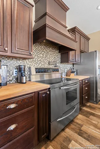 a large kitchen with stainless steel appliances granite countertop a stove and a sink