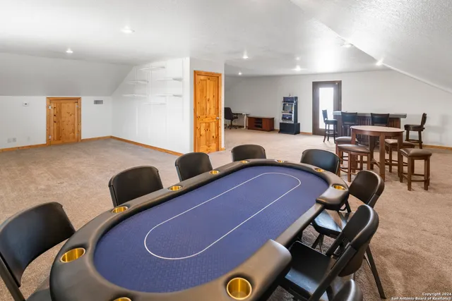 a view of two chairs and table in the balcony