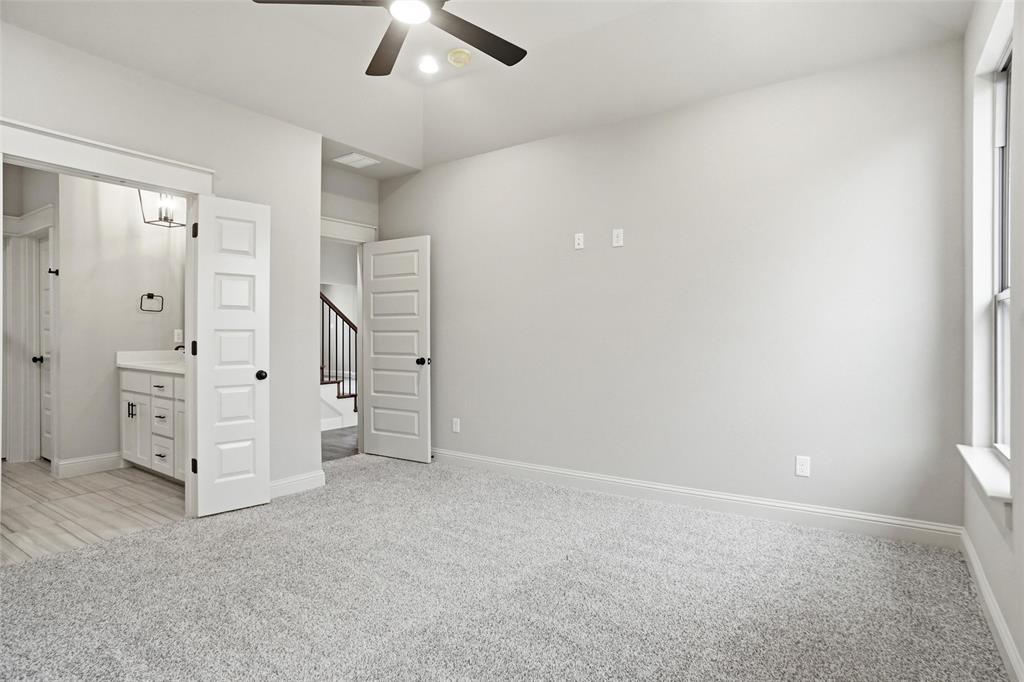 201 Legacy Boulevard Weatherford, TX 76085 - Photo 11 of 25 an empty room with a ceiling fan and window