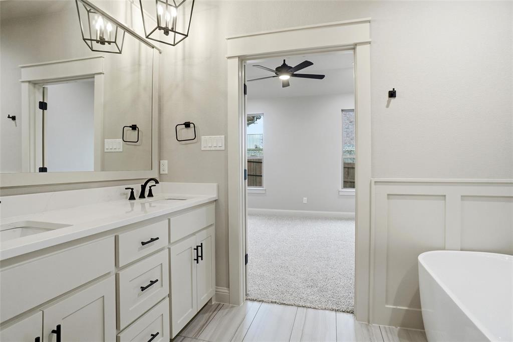 201 Legacy Boulevard Weatherford, TX 76085 - Photo 14 of 25 a bathroom with a granite countertop sink a toilet and shower