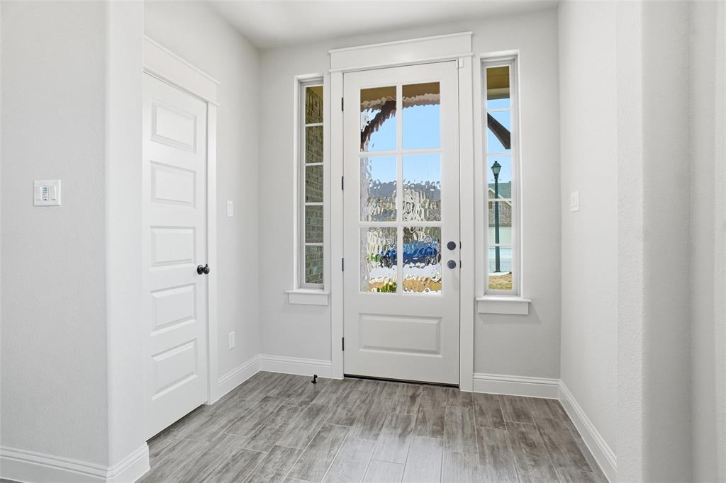 201 Legacy Boulevard Weatherford, TX 76085 - Photo 17 of 25 an entryway with wooden floor and cabinet