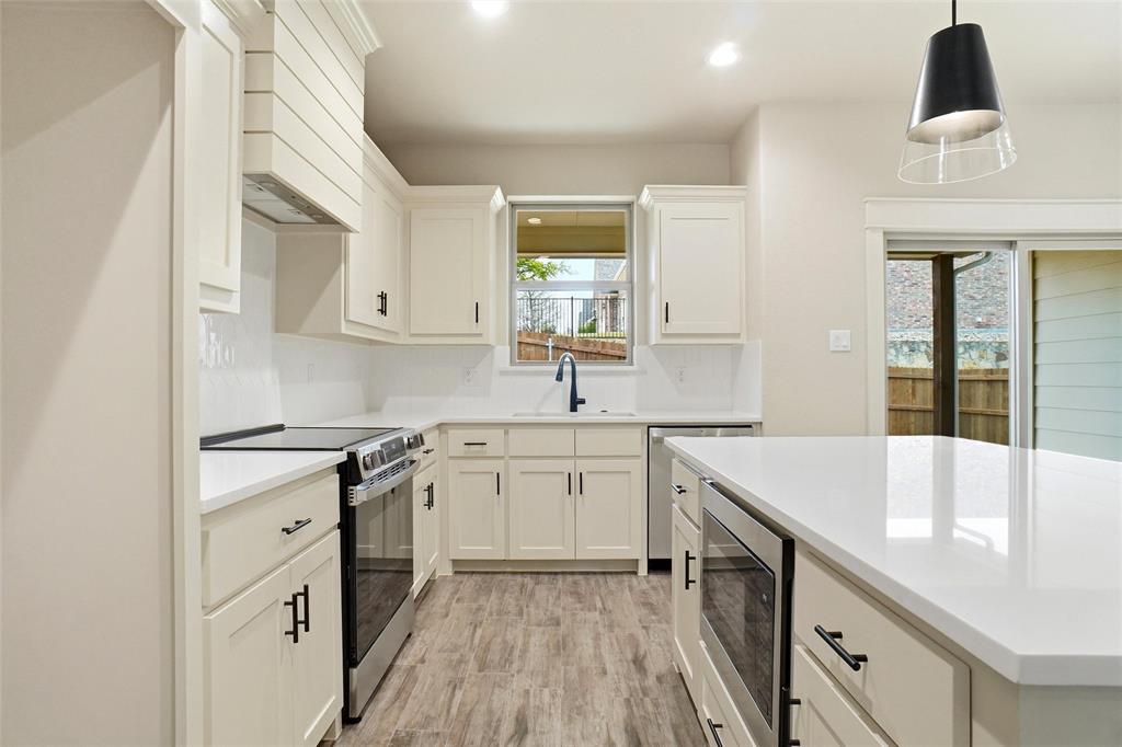 201 Legacy Boulevard Weatherford, TX 76085 - Photo 2 of 25 a kitchen with cabinets appliances and a sink