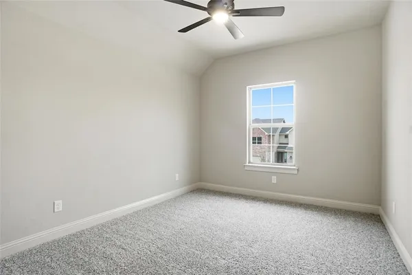 an empty room with a ceiling fan and window